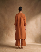 Women Rust Cotton Solid V-Neck Asymmetric Kurta Pant Dupatta Set