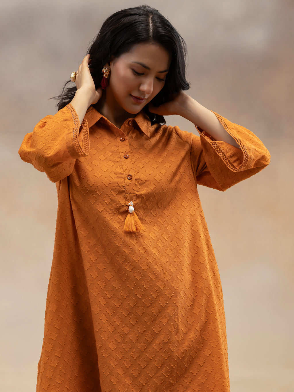 Women Rust Cotton Dobby Textured Kurta Set with Tassel Detail